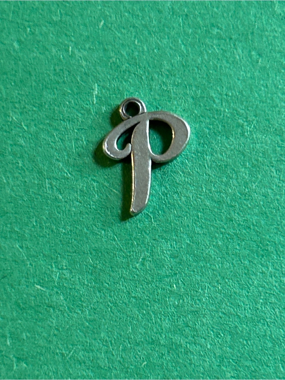 James Avery Silver Letter P Charm on Green Background